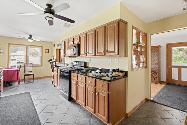 538 124th St, Franksville, WI 53126 - kitchen featuring black appliances, brown cabinetry, ceiling fan, and light tile patterned flooring