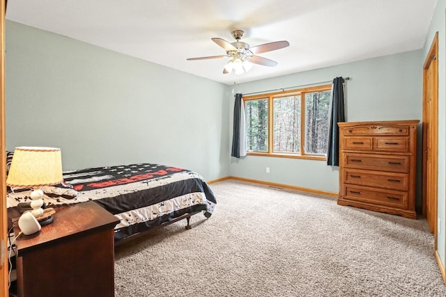 7496 River Rd, Lake Tomahawk, WI 54558 - bedroom with light colored carpet, baseboards, and ceiling fan