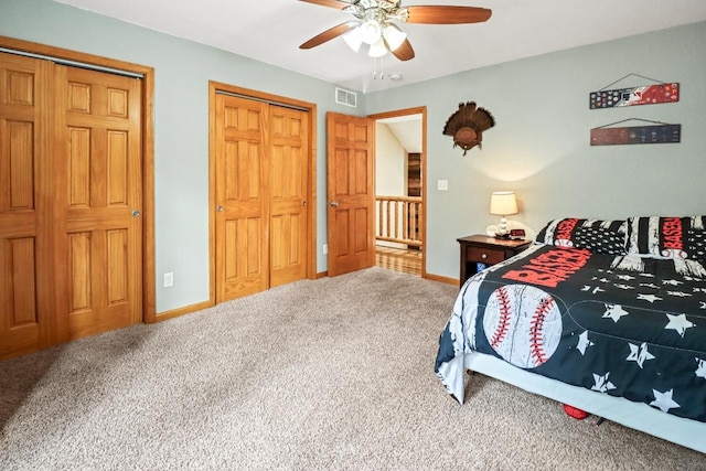 7496 River Rd, Lake Tomahawk, WI 54558 - bedroom featuring carpet, baseboards, ceiling fan, and two closets