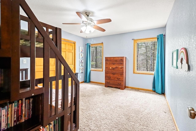 7496 River Rd, Lake Tomahawk, WI 54558 - bedroom with baseboards, carpet floors, a textured wall, and a ceiling fan
