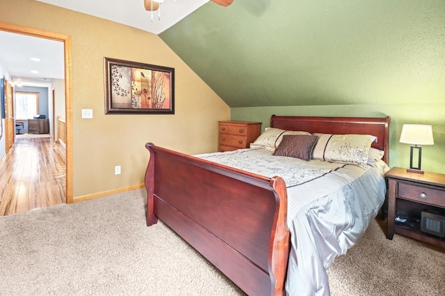 7496 River Rd, Lake Tomahawk, WI 54558 - bedroom with carpet floors, vaulted ceiling, baseboards, and ceiling fan