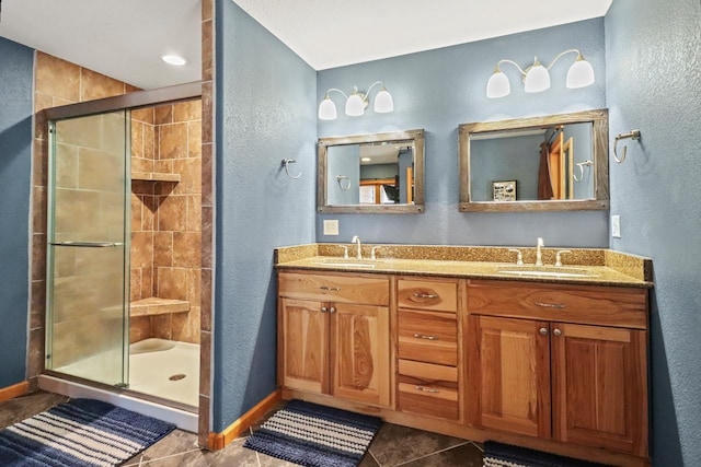 7496 River Rd, Lake Tomahawk, WI 54558 - bathroom with a textured wall, a shower stall, baseboards, tile patterned flooring, and double vanity