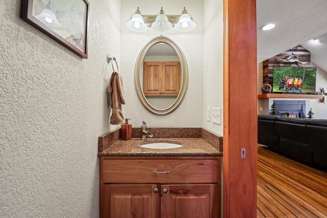 7496 River Rd, Lake Tomahawk, WI 54558 - bathroom featuring a textured wall, vanity, and recessed lighting