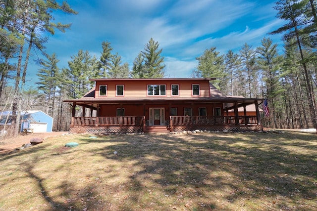 7496 River Rd, Lake Tomahawk, WI 54558 - rear view of house with an outdoor structure, covered porch, and a yard