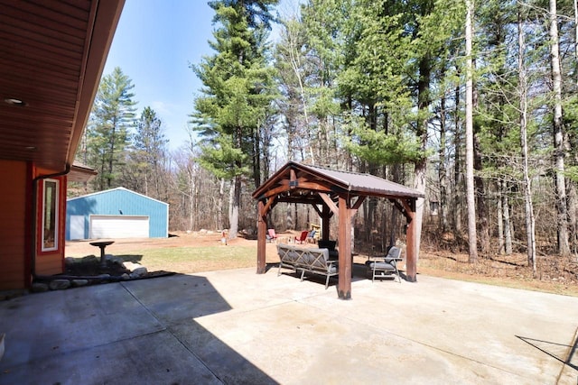 7496 River Rd, Lake Tomahawk, WI 54558 - view of patio featuring a gazebo, outdoor lounge area, an outbuilding, and a detached garage
