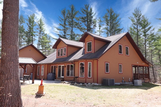 7496 River Rd, Lake Tomahawk, WI 54558 - back of property featuring central AC, a patio, a yard, and roof with shingles