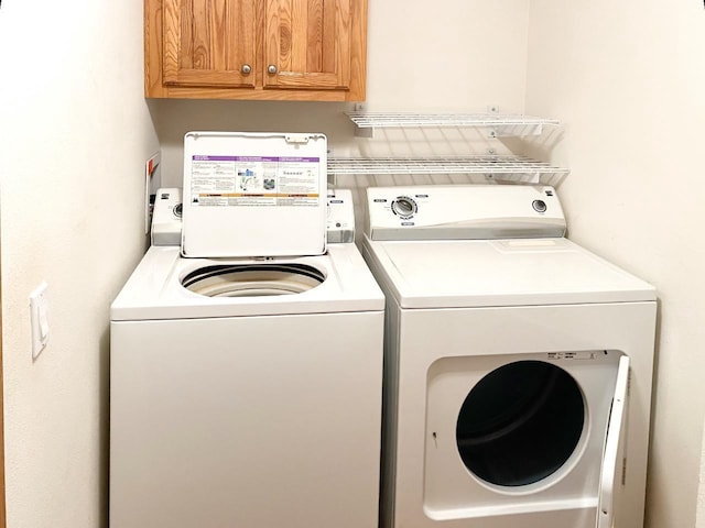 7496 River Rd, Lake Tomahawk, WI 54558 - washroom with cabinet space and washing machine and dryer