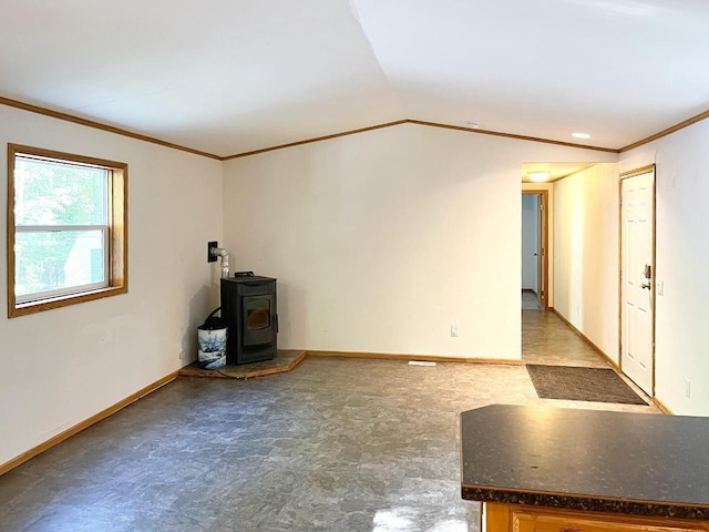 7496 River Rd, Lake Tomahawk, WI 54558 - unfurnished living room with a wood stove, ornamental molding, baseboards, lofted ceiling, and light flooring