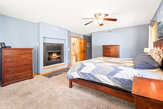 7496 River Rd, Lake Tomahawk, WI 54558 - carpeted bedroom with a lit fireplace and a ceiling fan
