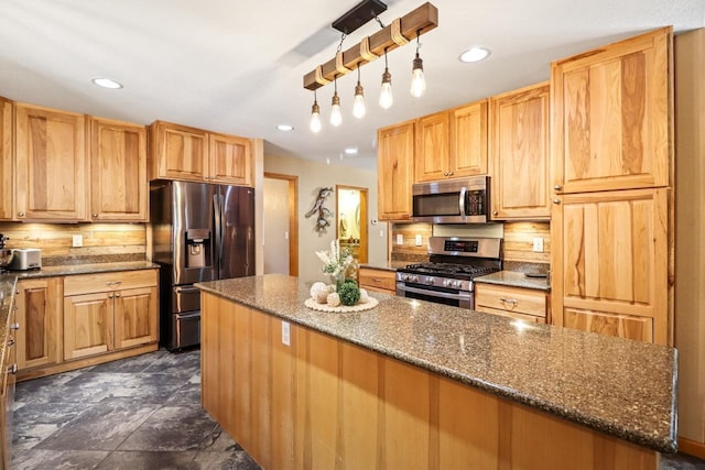 7496 River Rd, Lake Tomahawk, WI 54558 - kitchen with stainless steel appliances, a center island, dark stone counters, and recessed lighting