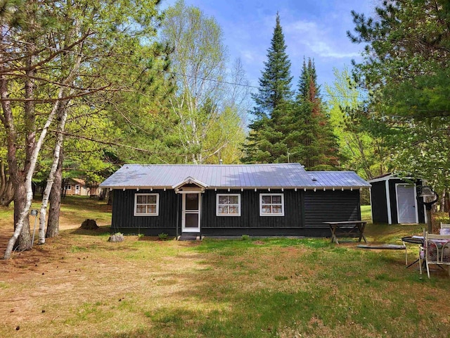 11586 Hidden Haven Dr, Hazelhurst, WI 54531 - view of front of property featuring board and batten siding, a front yard, and metal roof