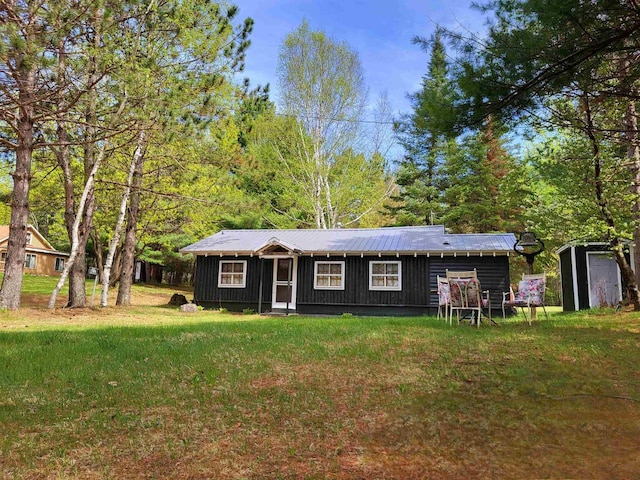 11586 Hidden Haven Dr, Hazelhurst, WI 54531 - view of front facade with a front lawn and board and batten siding
