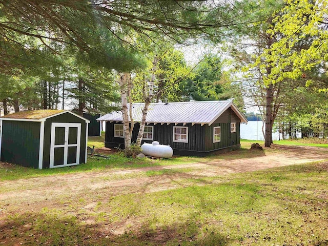 11586 Hidden Haven Dr, Hazelhurst, WI 54531 - rear view of property featuring a lawn, metal roof, and board and batten siding