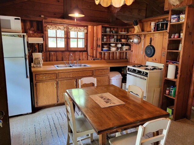 11586 Hidden Haven Dr, Hazelhurst, WI 54531 - kitchen with open shelves, white appliances, light colored carpet, a sink, and wooden walls