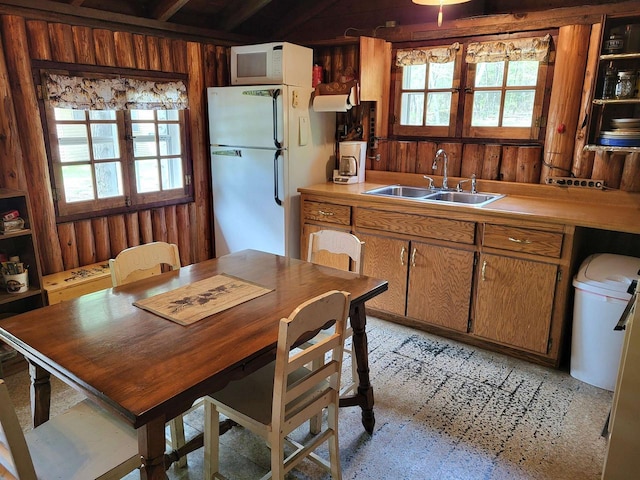 11586 Hidden Haven Dr, Hazelhurst, WI 54531 - kitchen with white appliances, a sink, wood walls, light countertops, and brown cabinetry
