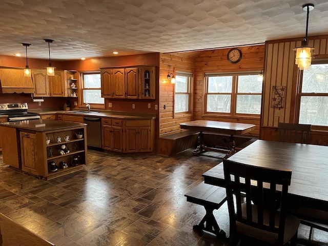 221545 Azalea Rd, Wausau, WI 54401 - kitchen featuring open shelves, appliances with stainless steel finishes, a sink, brown cabinetry, and a center island