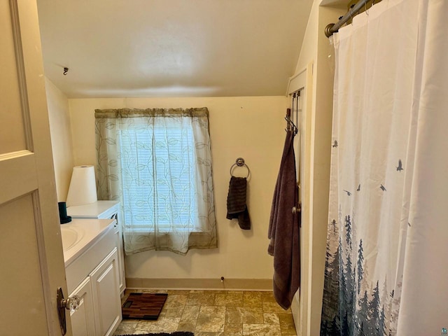 514 W 9th Ave, Ashland, WI 54806 - bathroom with baseboards, vanity, and a shower with curtain