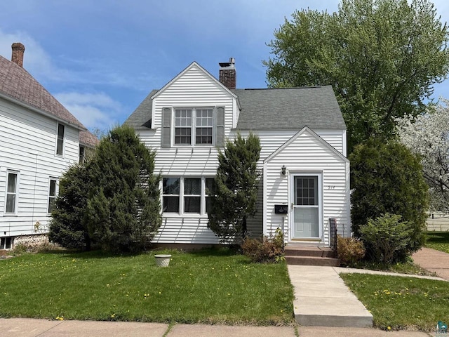 514 W 9th Ave, Ashland, WI 54806 - view of front of home with a front yard and a chimney
