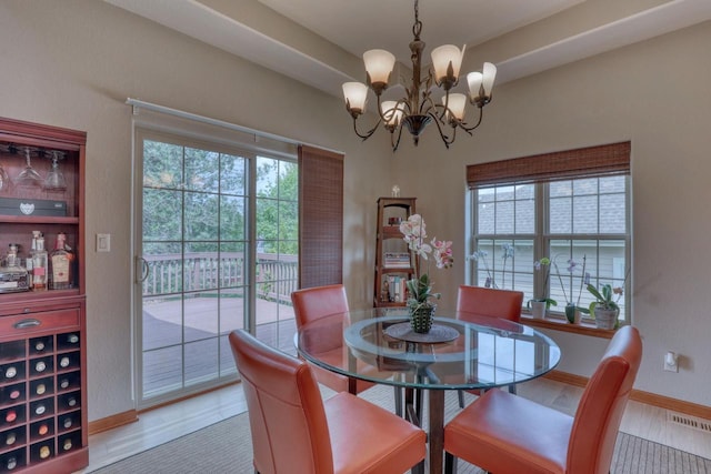 1826 Stonebridge Rd, Waukesha, WI 53188 - dining area featuring wood finished floors, a chandelier, and baseboards