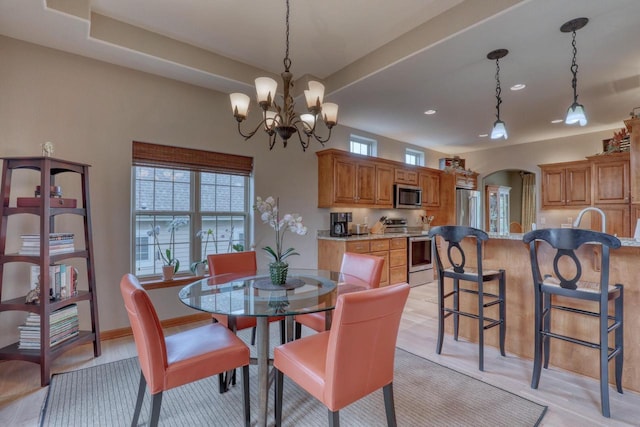 1826 Stonebridge Rd, Waukesha, WI 53188 - dining space featuring healthy amount of natural light, a chandelier, arched walkways, and recessed lighting