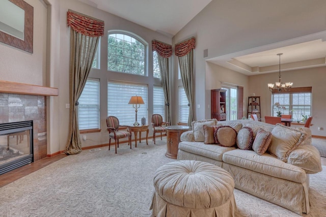 1826 Stonebridge Rd, Waukesha, WI 53188 - living room featuring a chandelier, high vaulted ceiling, baseboards, a tile fireplace, and carpet floors