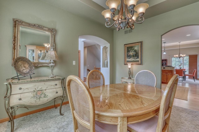 1826 Stonebridge Rd, Waukesha, WI 53188 - dining area with arched walkways, a chandelier, and baseboards