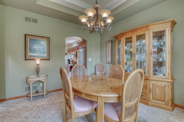 1826 Stonebridge Rd, Waukesha, WI 53188 - dining area featuring arched walkways, light carpet, baseboards, and a chandelier
