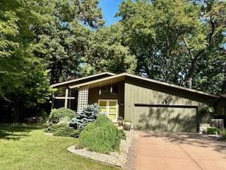 3914 Priscilla Ln, Madison, WI 53705 - view of front of home with driveway, a front yard, and a garage