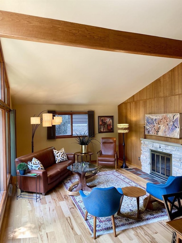 3914 Priscilla Ln, Madison, WI 53705 - living room with wooden walls, light wood-style flooring, and a fireplace