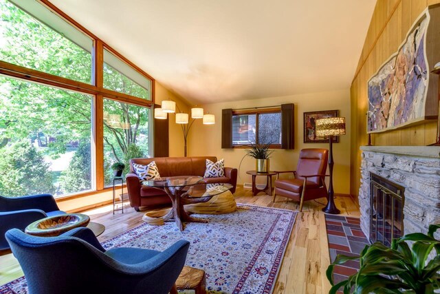 3914 Priscilla Ln, Madison, WI 53705 - living area with vaulted ceiling, a stone fireplace, and wood finished floors