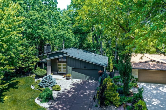 3914 Priscilla Ln, Madison, WI 53705 - mid-century home featuring a chimney, concrete driveway, a garage, and a front lawn