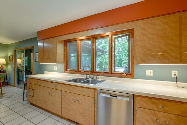 3914 Priscilla Ln, Madison, WI 53705 - kitchen with stainless steel dishwasher, a sink, light countertops, and light tile patterned floors