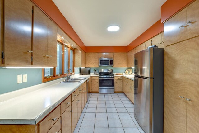 3914 Priscilla Ln, Madison, WI 53705 - kitchen with appliances with stainless steel finishes, a sink, light tile patterned floors, light countertops, and light brown cabinets