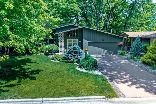 3914 Priscilla Ln, Madison, WI 53705 - mid-century home featuring a garage, a front yard, driveway, and board and batten siding