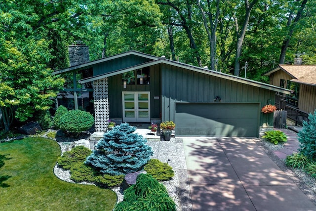 3914 Priscilla Ln, Madison, WI 53705 - mid-century home with a chimney, a garage, and driveway