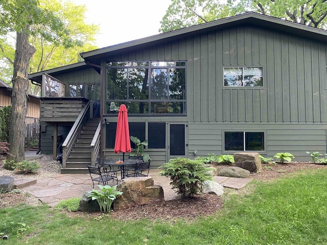 3914 Priscilla Ln, Madison, WI 53705 - rear view of house with stairs, a wooden deck, a patio, and board and batten siding