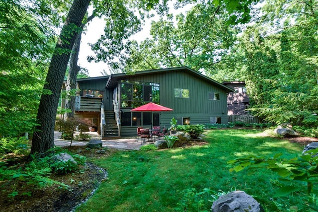 3914 Priscilla Ln, Madison, WI 53705 - rear view of house featuring a patio area, a lawn, board and batten siding, and stairs