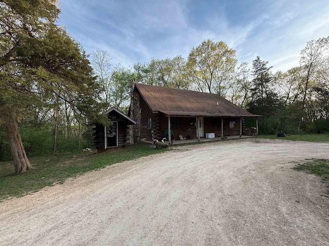 N8718 Starr Rd, Portage, WI 53901 - log cabin with log siding, covered porch, and driveway
