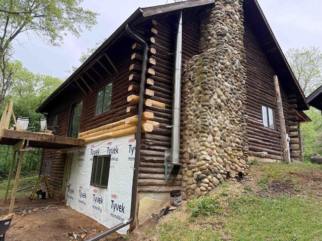 N8718 Starr Rd, Portage, WI 53901 - view of side of property with log siding and a chimney