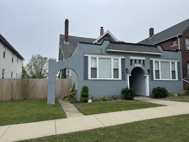 3727 E Layton Ave, Cudahy, WI 53110 - view of front of property featuring stucco siding, a chimney, and roof with shingles