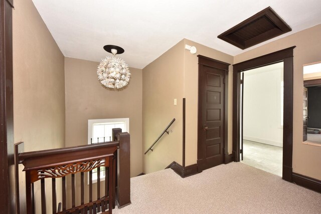 3727 E Layton Ave, Cudahy, WI 53110 - staircase featuring a chandelier, carpet floors, and baseboards