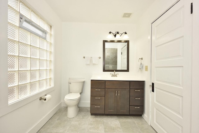 3727 E Layton Ave, Cudahy, WI 53110 - bathroom with baseboards, vanity, toilet, and tile patterned floors