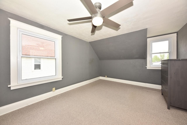 3727 E Layton Ave, Cudahy, WI 53110 - additional living space with light colored carpet, a ceiling fan, vaulted ceiling, and baseboards