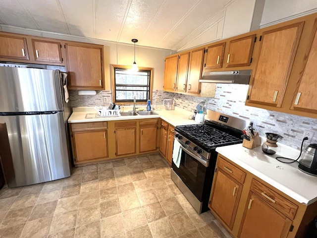 3185 S Faust Lake Rd, Rhinelander, WI 54501 - kitchen featuring appliances with stainless steel finishes, a sink, under cabinet range hood, and decorative backsplash