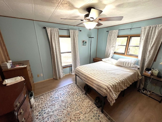 3185 S Faust Lake Rd, Rhinelander, WI 54501 - bedroom with light wood-type flooring, ceiling fan, and baseboards