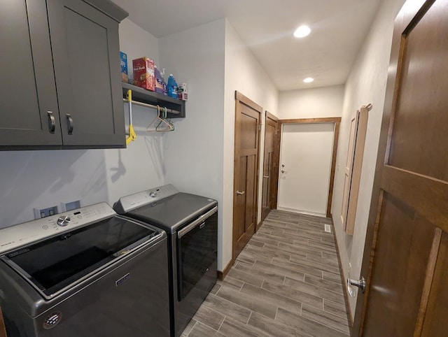 5235 Killdeer Ln, Oshkosh, WI 54901 - laundry room with washing machine and dryer, cabinet space, wood finished floors, recessed lighting, and baseboards