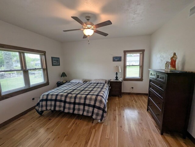 5235 Killdeer Ln, Oshkosh, WI 54901 - bedroom featuring light wood-style flooring, baseboards, and ceiling fan