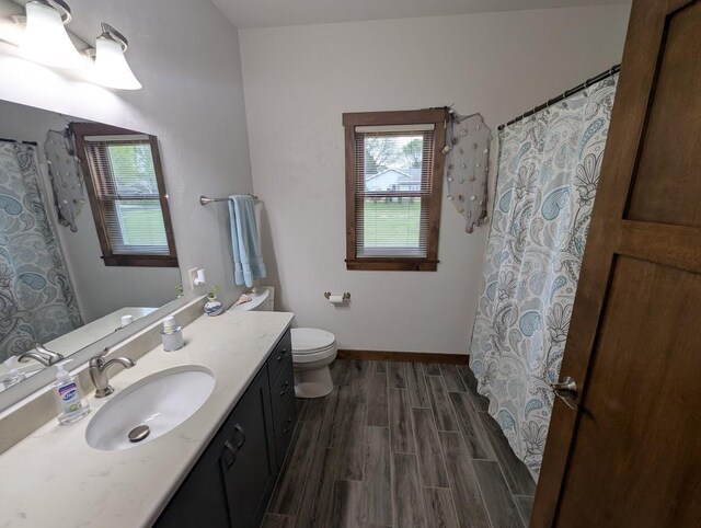5235 Killdeer Ln, Oshkosh, WI 54901 - full bathroom with wood finished floors, healthy amount of natural light, toilet, and vanity