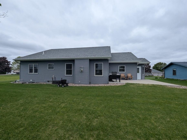 5235 Killdeer Ln, Oshkosh, WI 54901 - rear view of house featuring a patio, a yard, driveway, and roof with shingles