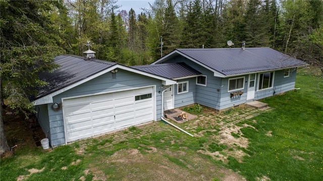 4620W Sweitzer Rd, Winter, WI 54896 - view of front of house with driveway, metal roof, a front yard, a garage, and a standing seam roof